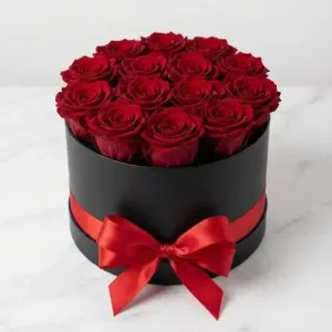 Luxurious round hat box filled with 12 fresh premium red roses and satin ribbon by Athens Flower Shop