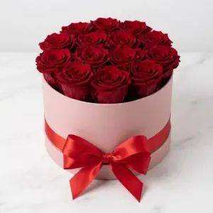Premium arrangement of 12 fresh red roses nestled in a luxury designer gift box